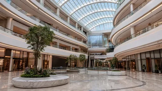 A Dubai mall atrium under a vaulted glass roof (AI-generated image)
