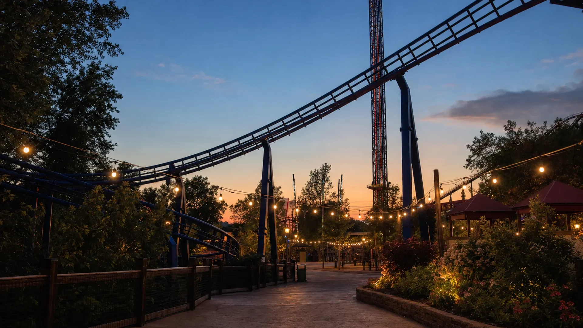 A rollercoaster track above a theme park walkway at dusk (AI-generated image)